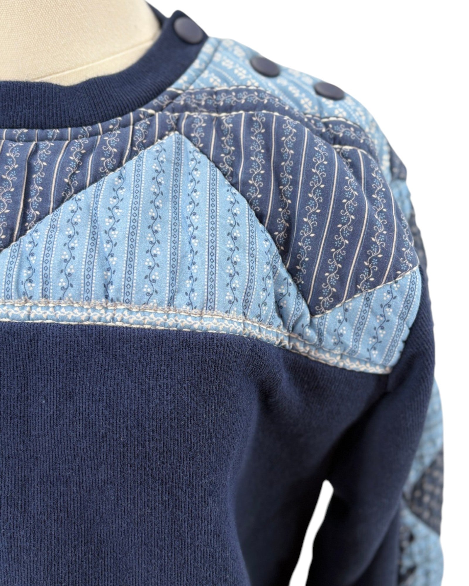 Sea NY navy blue sweater with a patchwork pattern on a mannequin against a white background