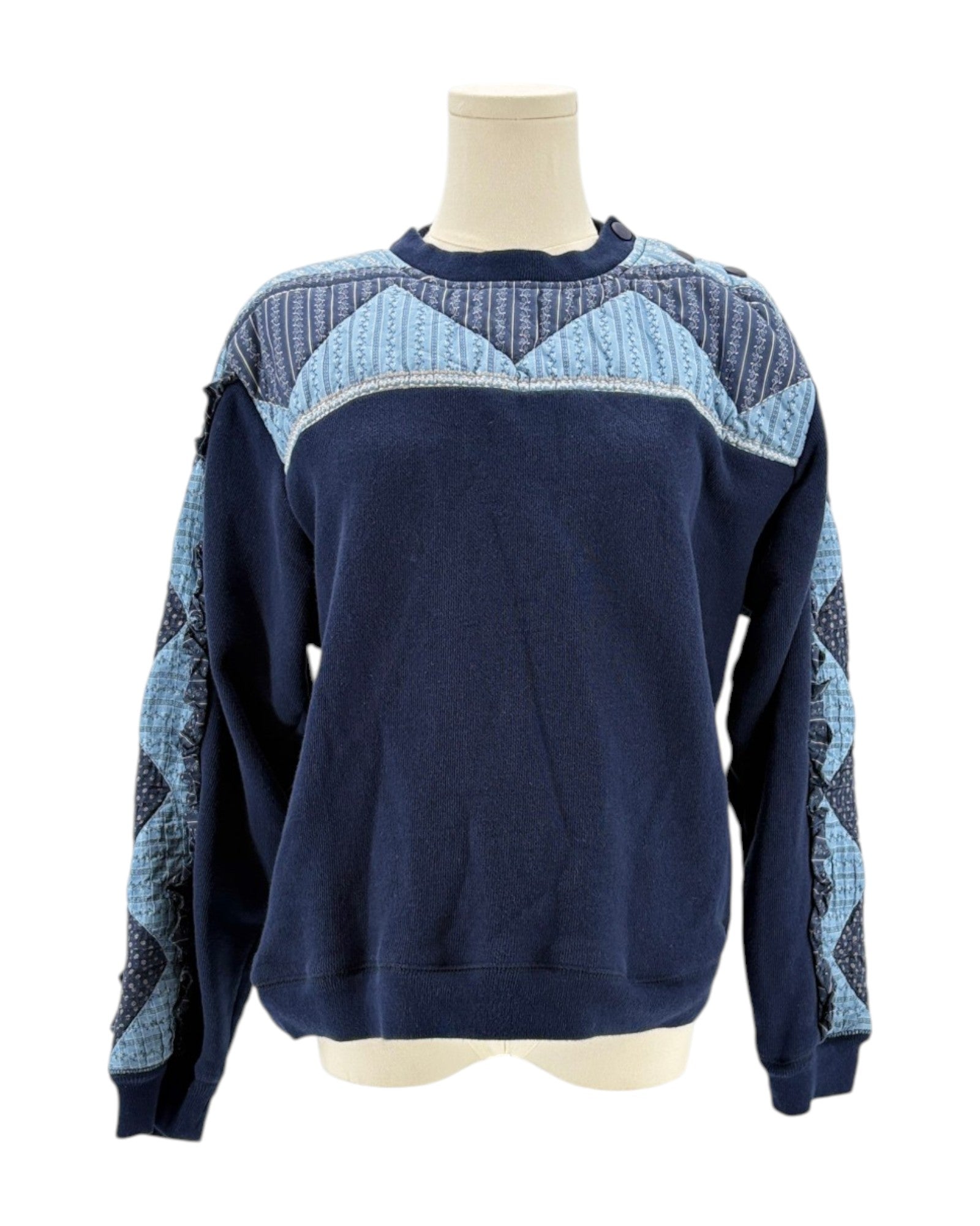 Sea NY navy blue sweater with a patchwork pattern on a mannequin against a white background