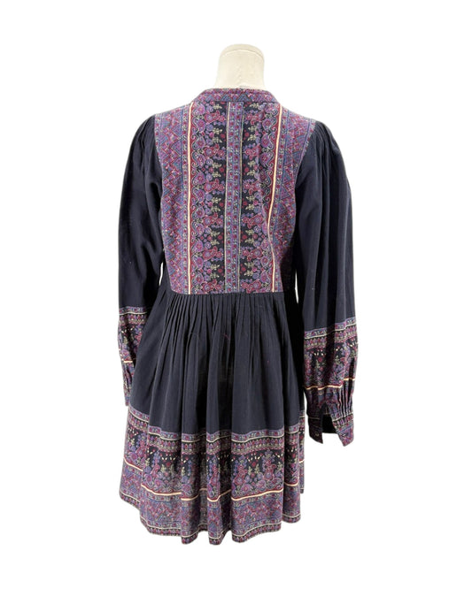 Black dress with colorful patterned details on a mannequin against a white background