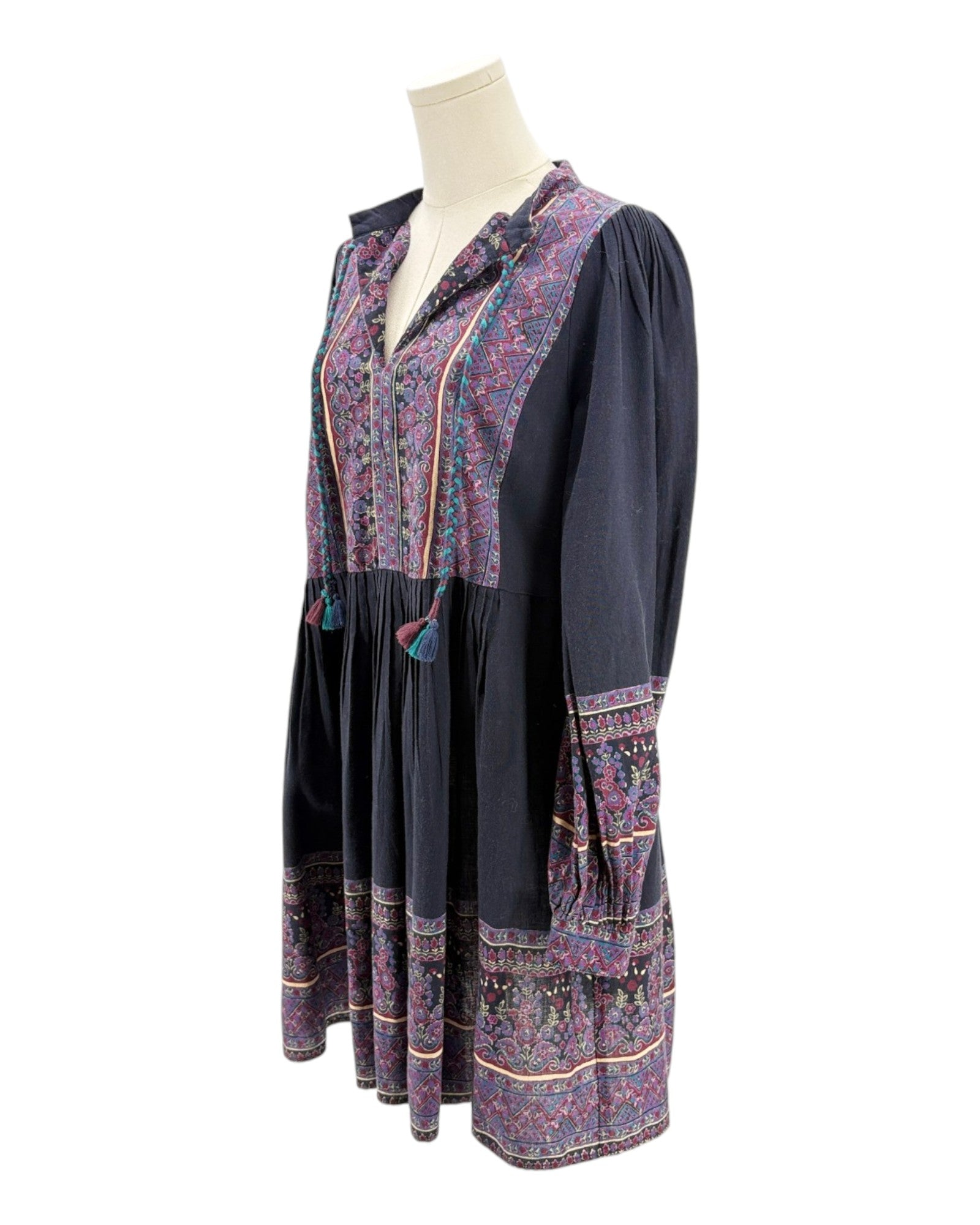 Black dress with colorful patterns on a mannequin against a white background