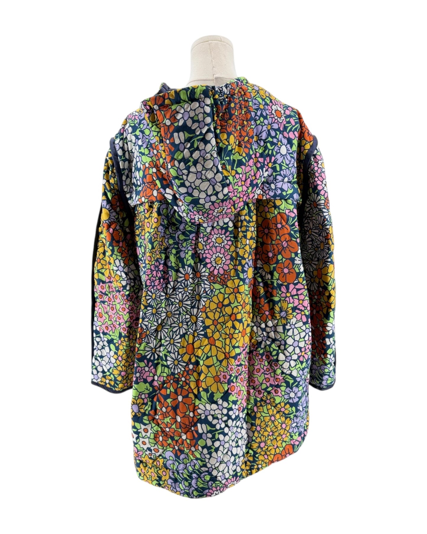 Colorful floral-patterned jacket on a mannequin against a white background