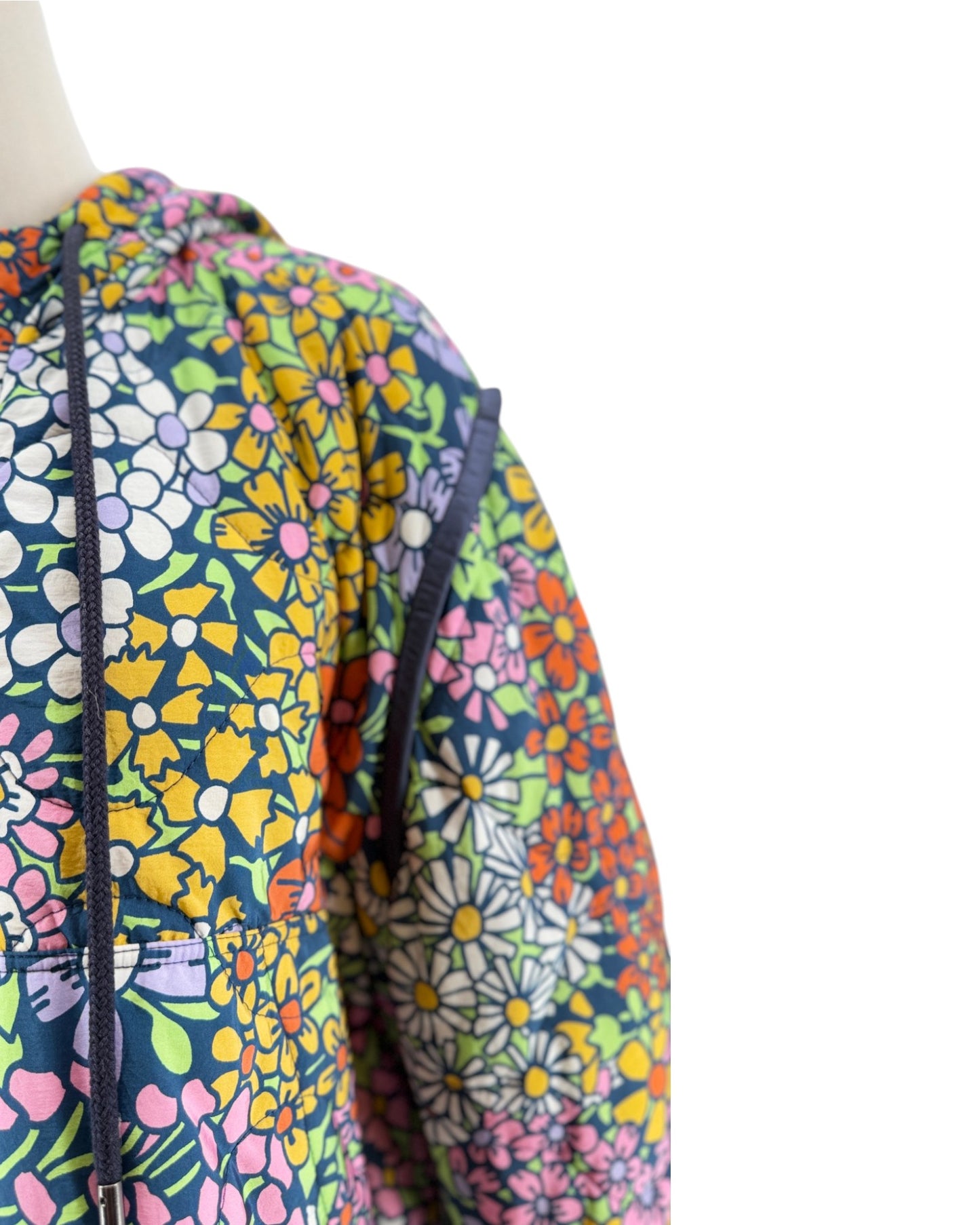 Colorful floral-patterned jacket on a mannequin with a white background