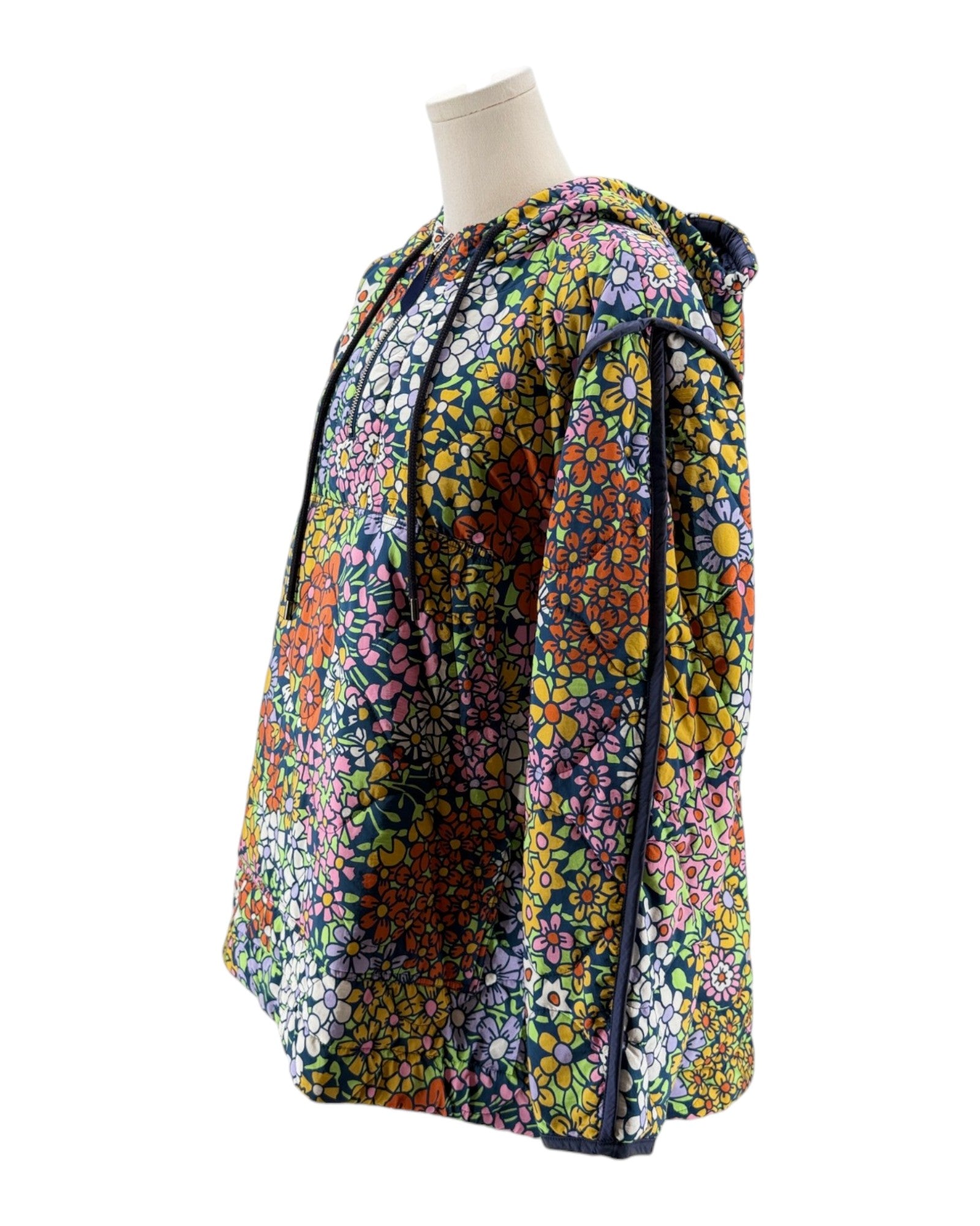 Colorful floral-patterned garment on a mannequin against a white background