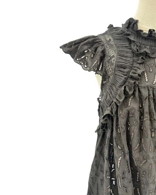 Black embroidered dress on a mannequin against a white background