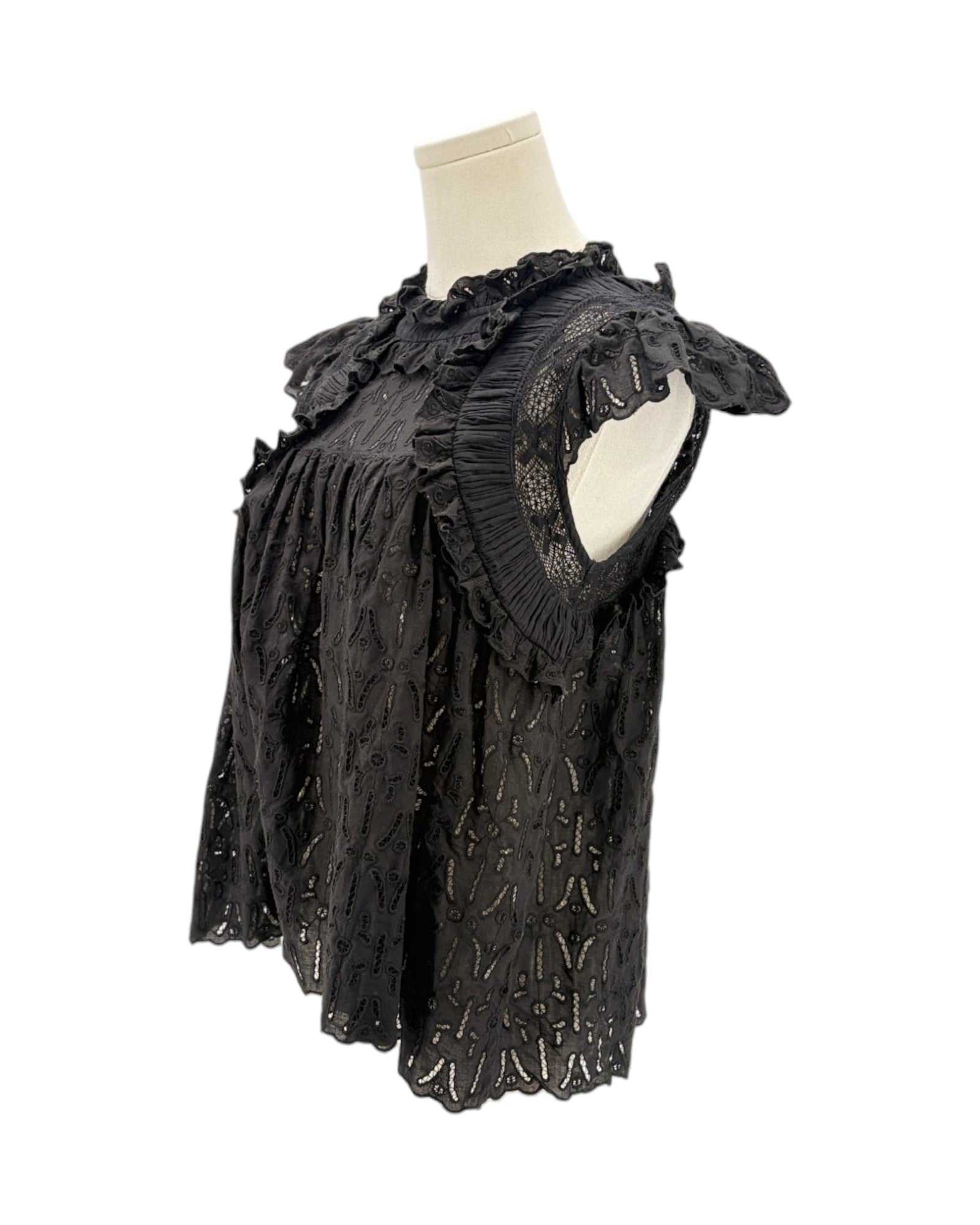 Black lace top on a mannequin against a white background