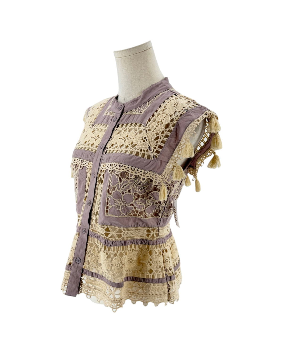 A lavender and cream bohemian-style embroidered blouse displayed on a mannequin torso against a white background.