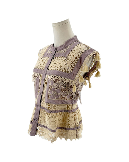 A lavender and cream bohemian-style embroidered blouse displayed on a mannequin torso against a white background.