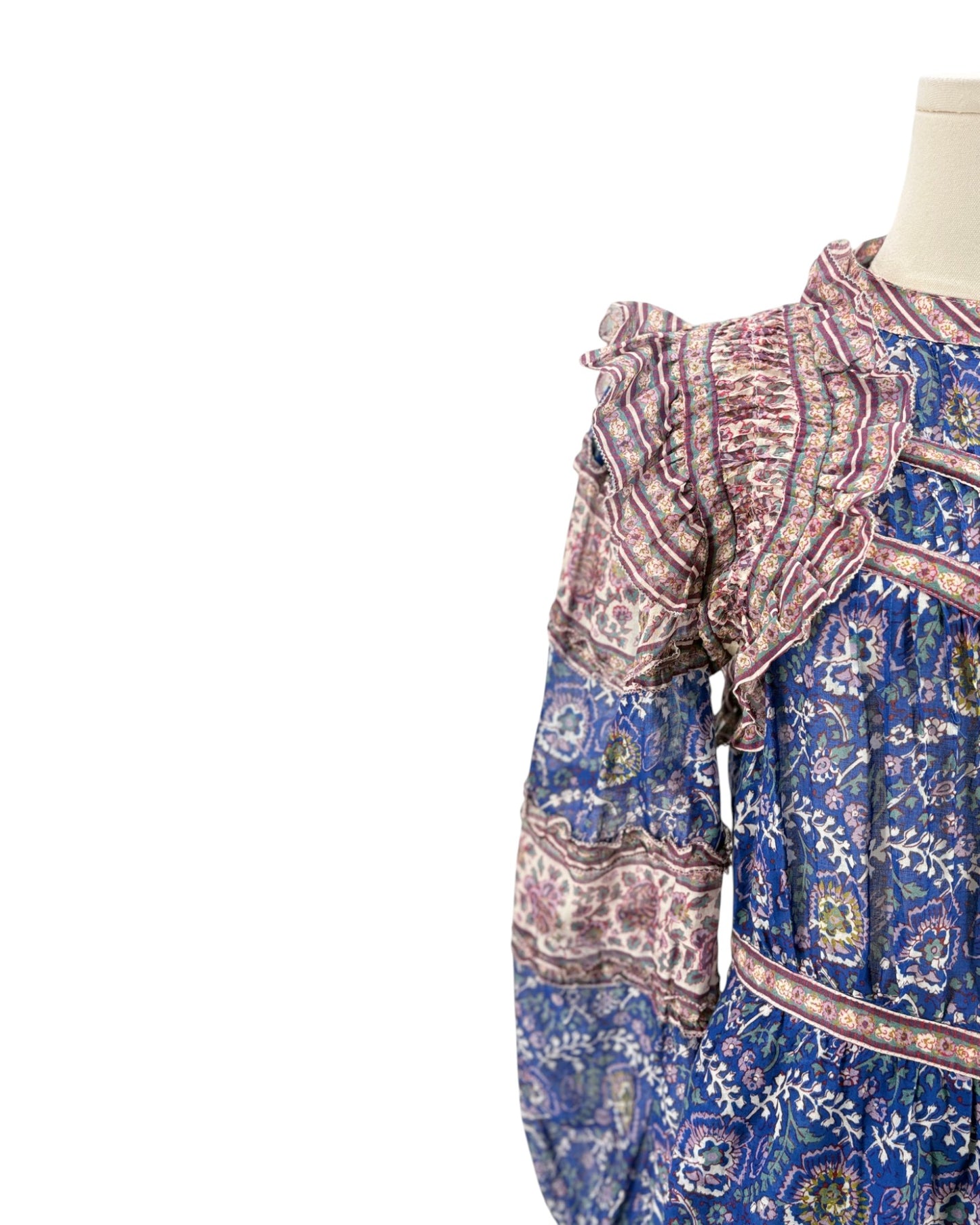 Mannequin wearing a patterned dress with a white background