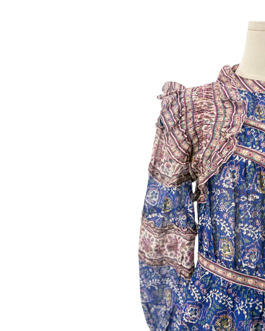 Mannequin wearing a patterned dress with a white background