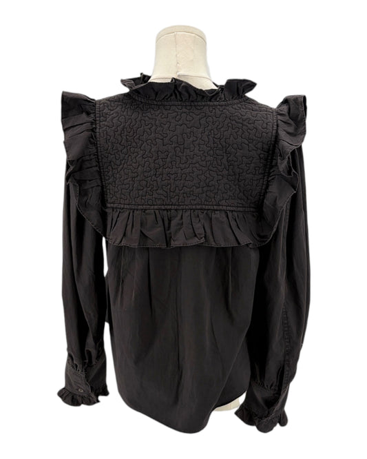 Dark gray blouse with ruffled details on a mannequin against a white background