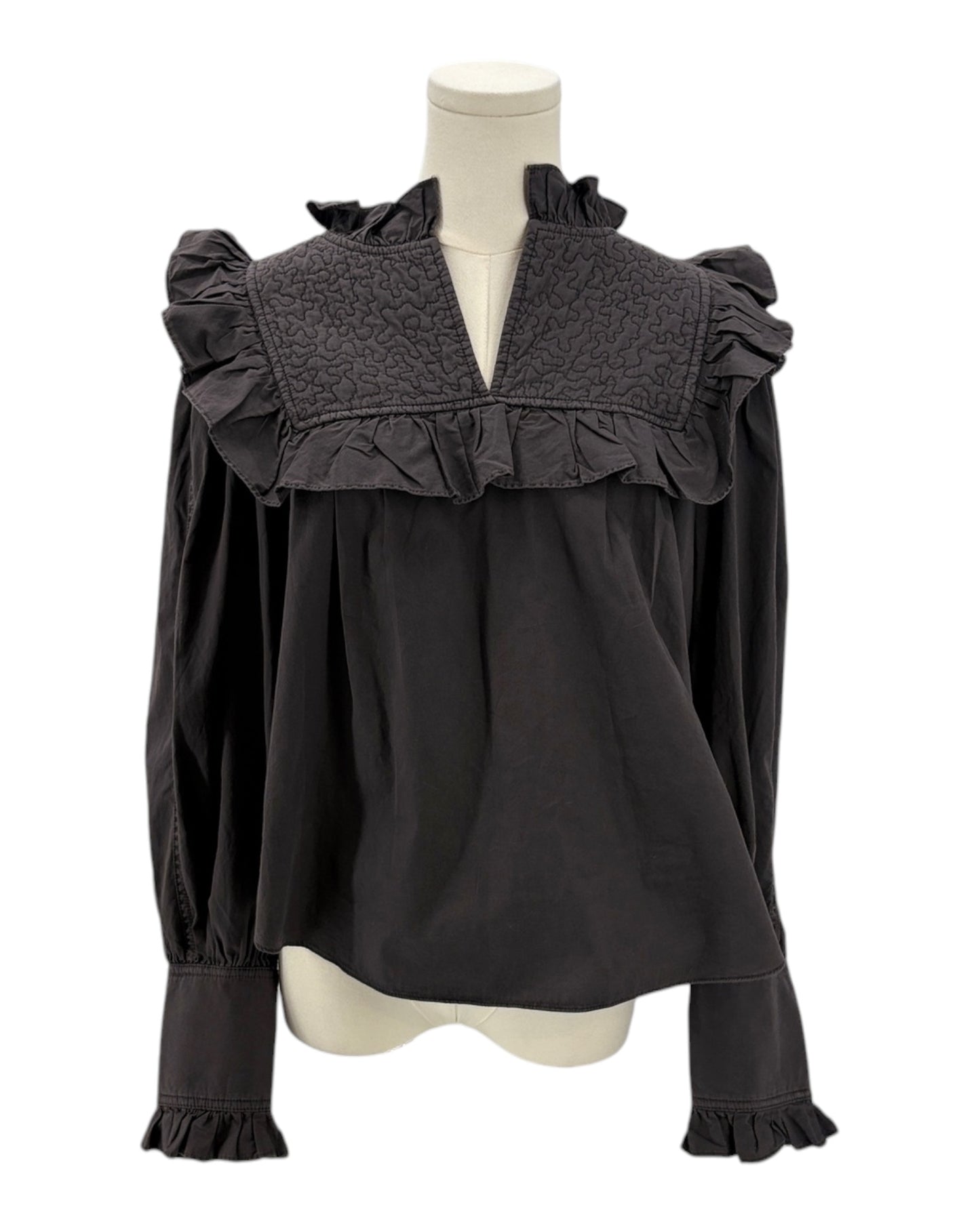 Dark gray blouse with ruffled details on a mannequin against a white background