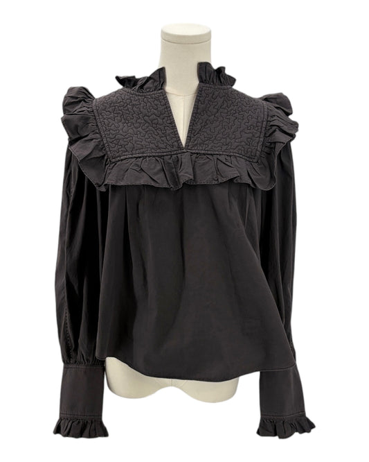 Dark gray blouse with ruffled details on a mannequin against a white background