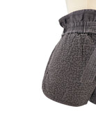 Gray quilted shorts on white background