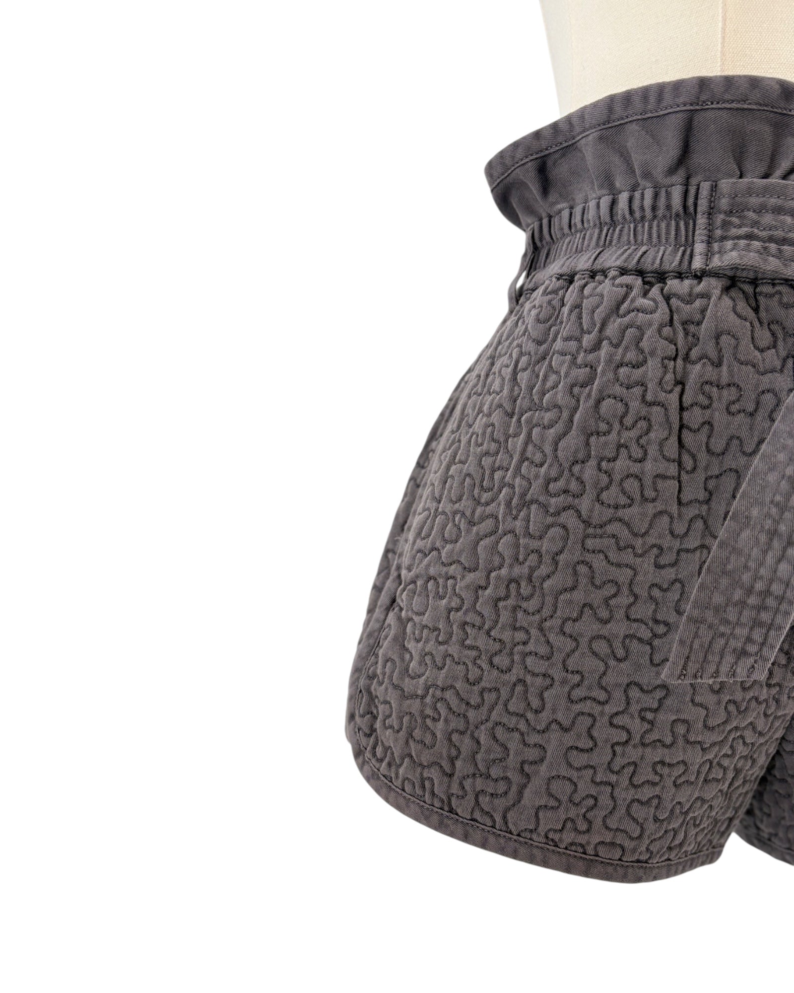 Gray quilted shorts on white background
