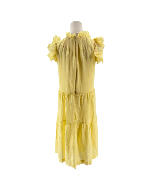 Yellow dress on a mannequin against a white background