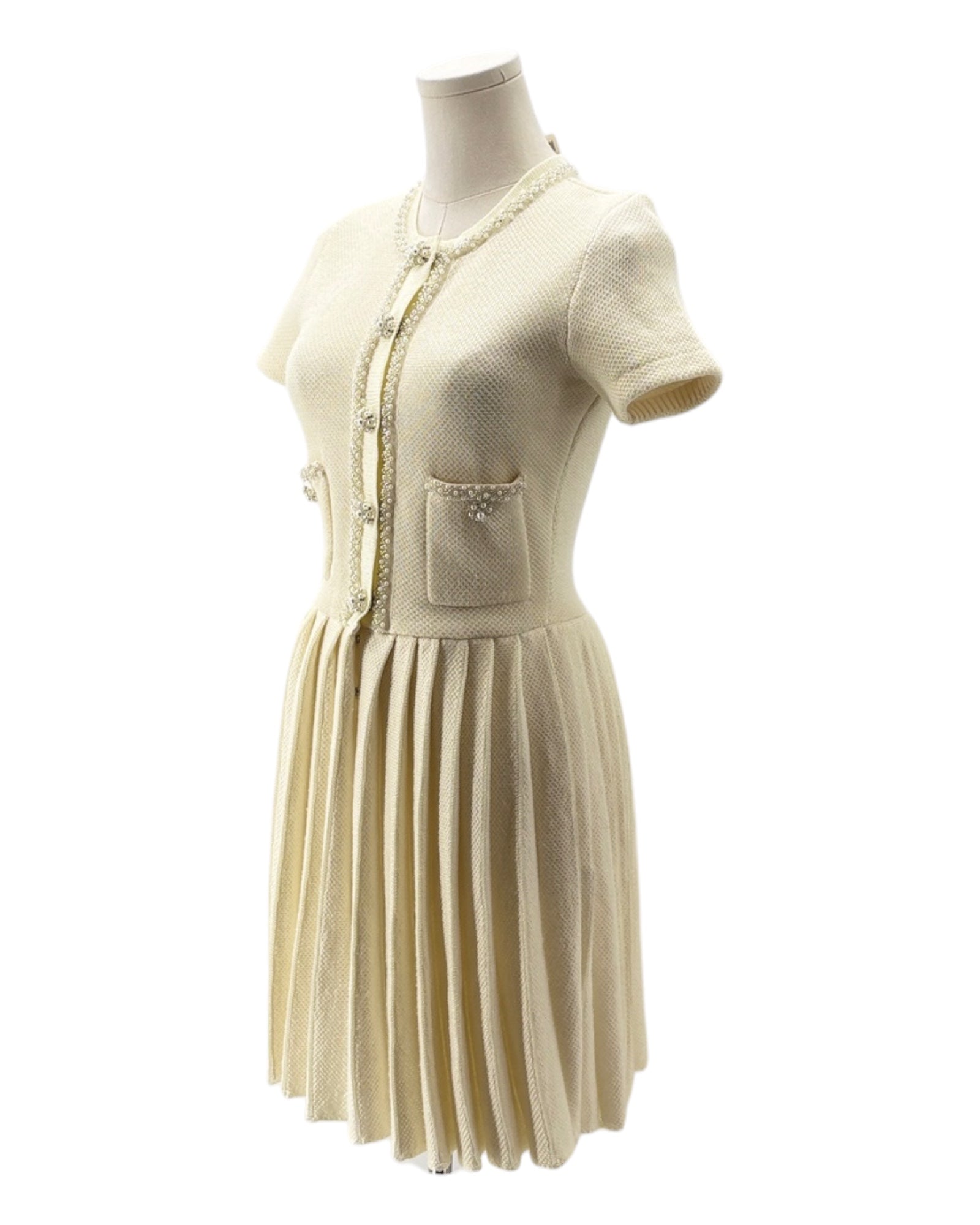 Beige dress on a mannequin against a white background