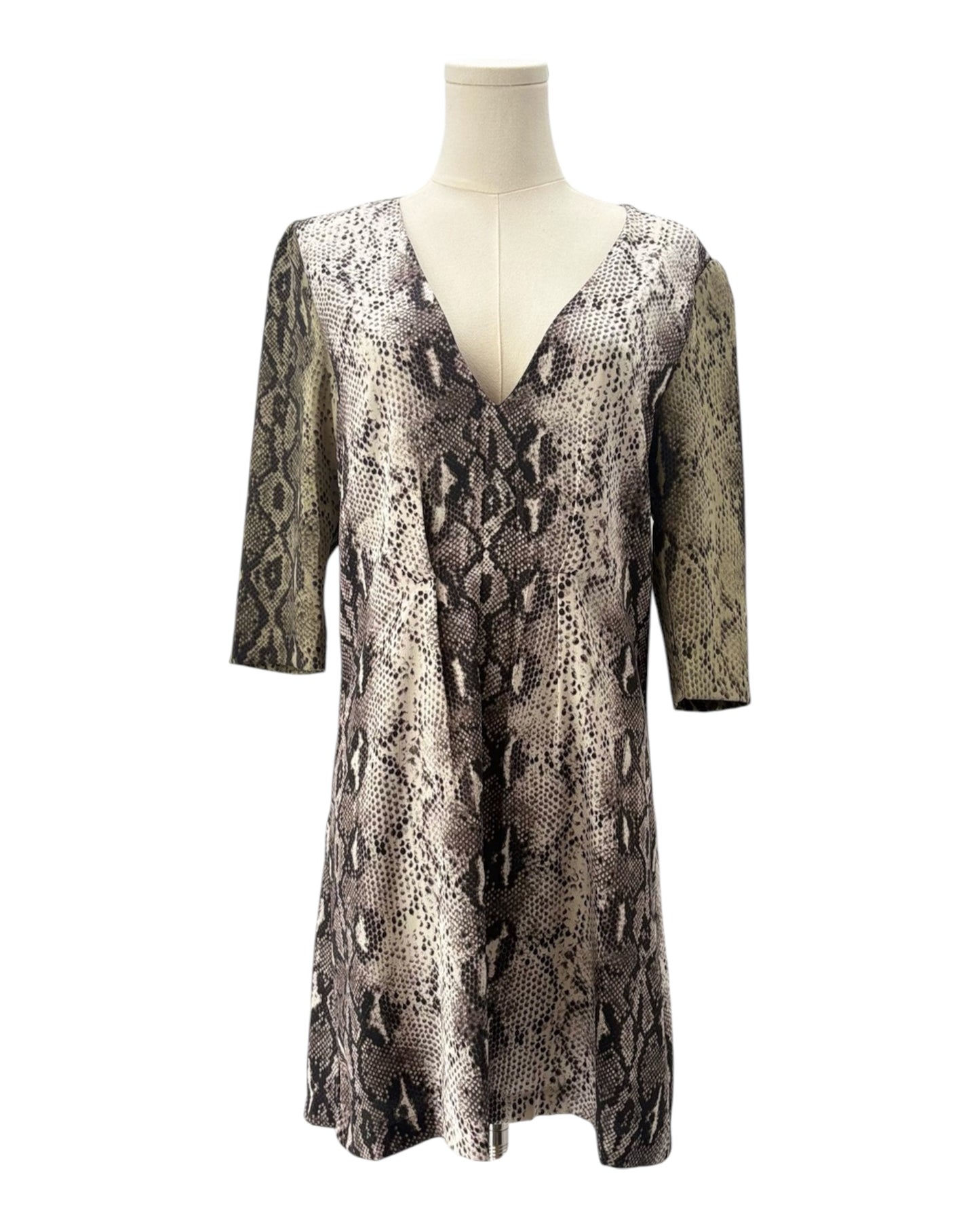 Snakeskin patterned dress on a mannequin against a white background