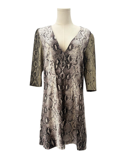 Snakeskin patterned dress on a mannequin against a white background