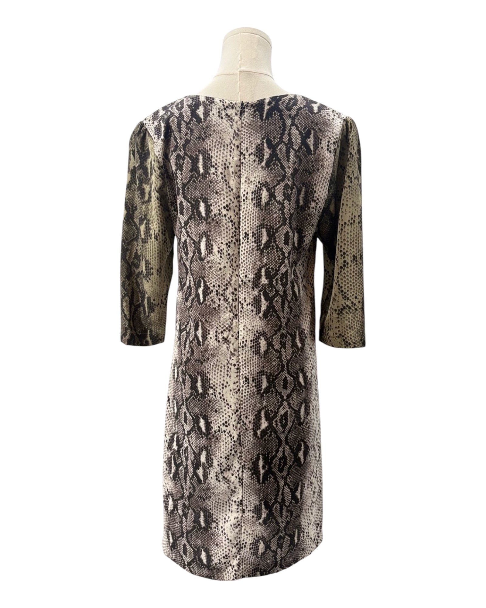 Snakeskin pattern dress on a mannequin against a white background