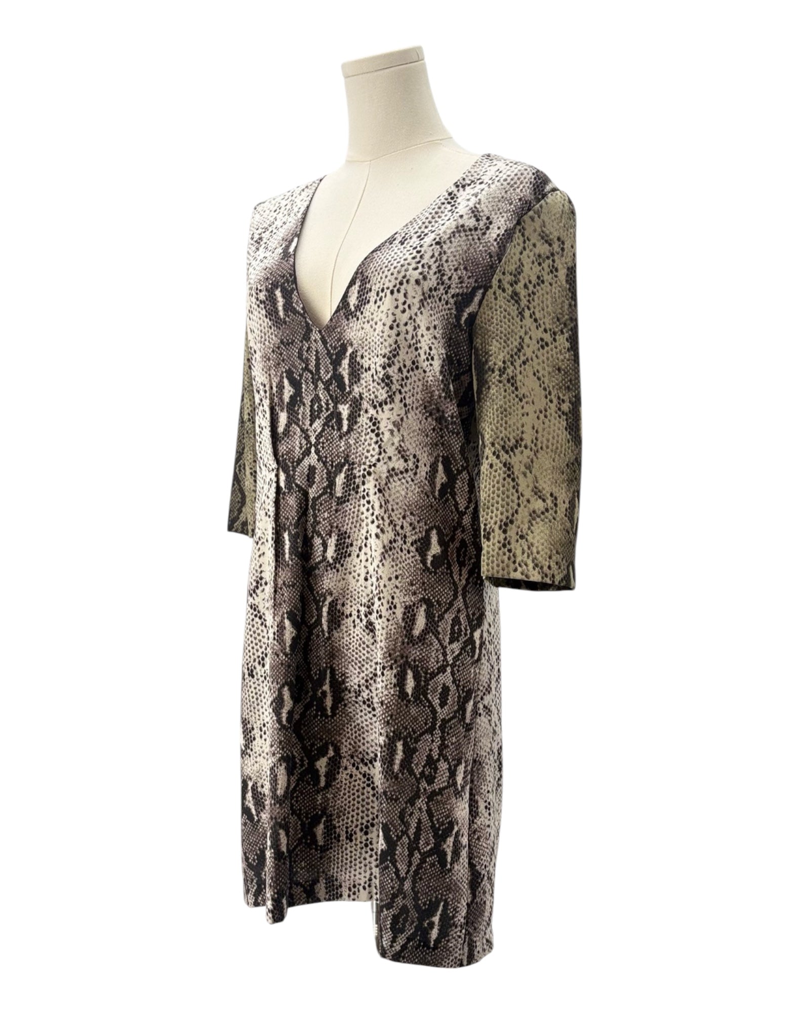 Snakeskin patterned dress on a mannequin against a white background