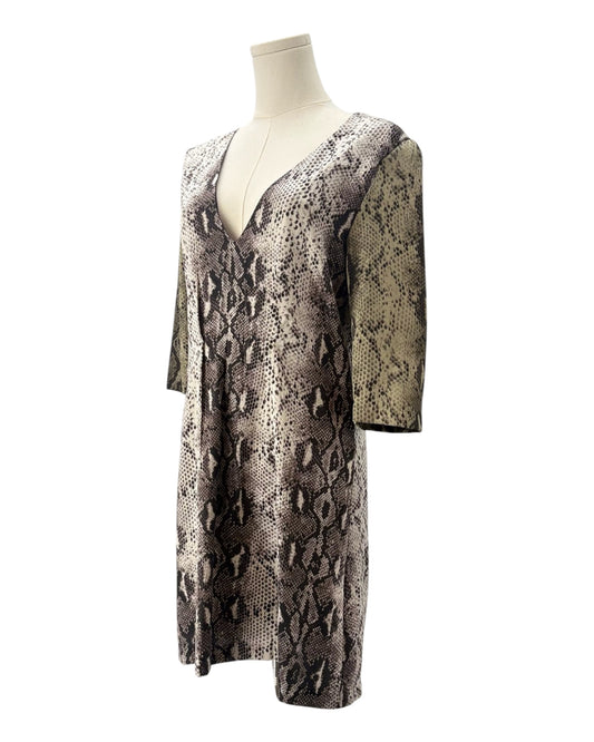 Snakeskin patterned dress on a mannequin against a white background