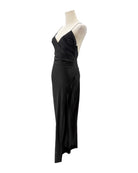 Black evening gown on a mannequin against a white background