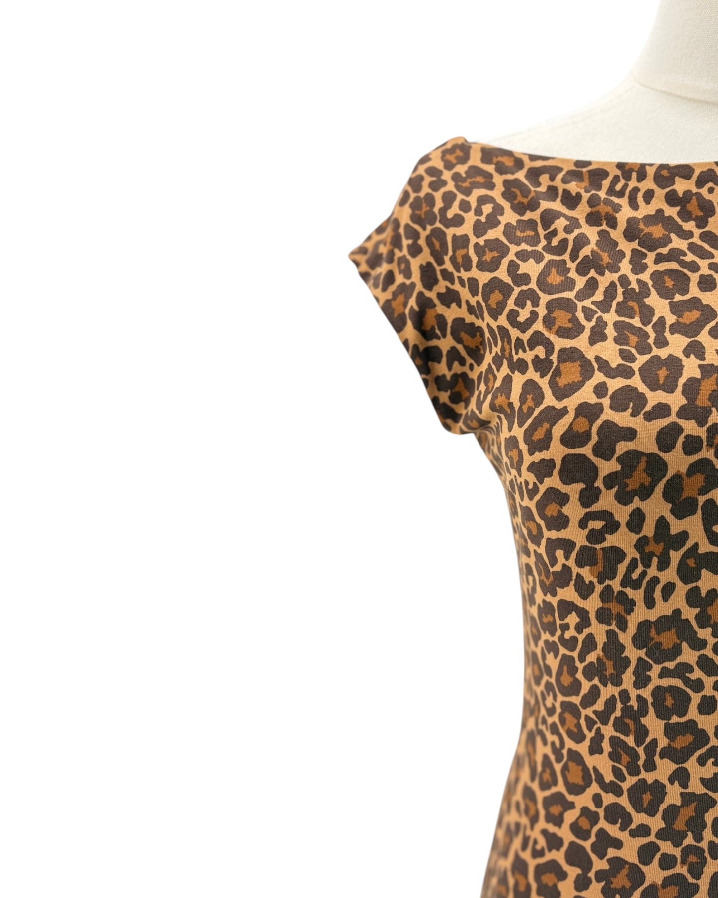 A close-up of a leopard print top on a mannequin torso against a plain white background.