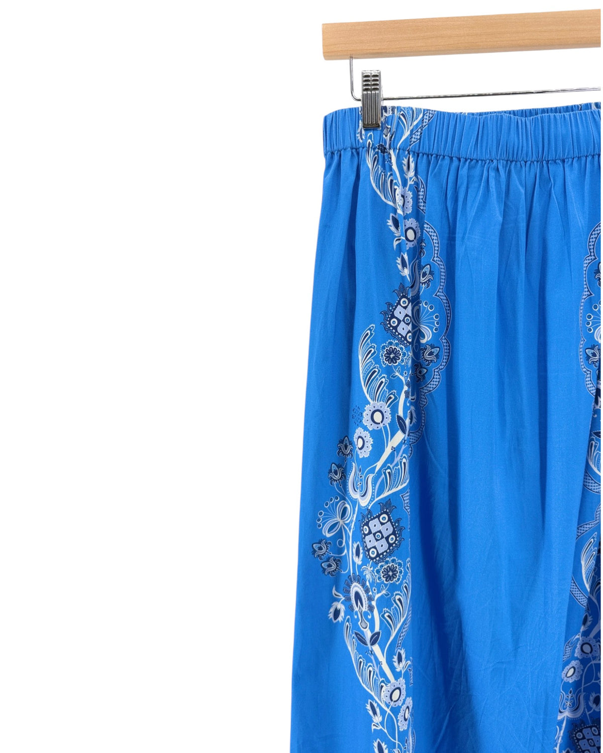 Bright blue midi skirt with a black and white bandana print down the front and sides on a white background