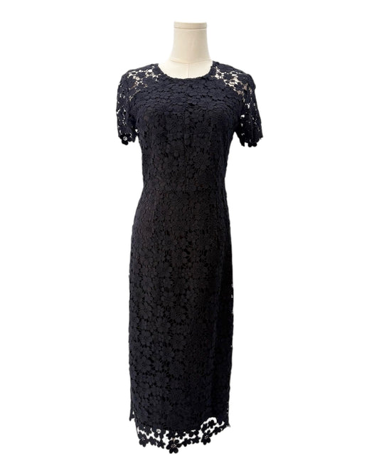 Black lace dress on a mannequin against a white background