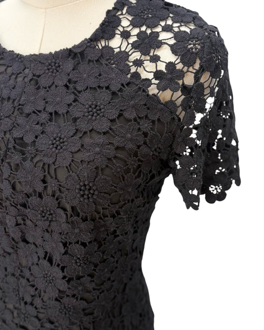Black lace dress on a mannequin with a white background