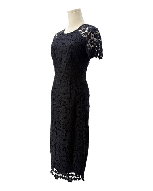 Black lace dress on a mannequin against a white background