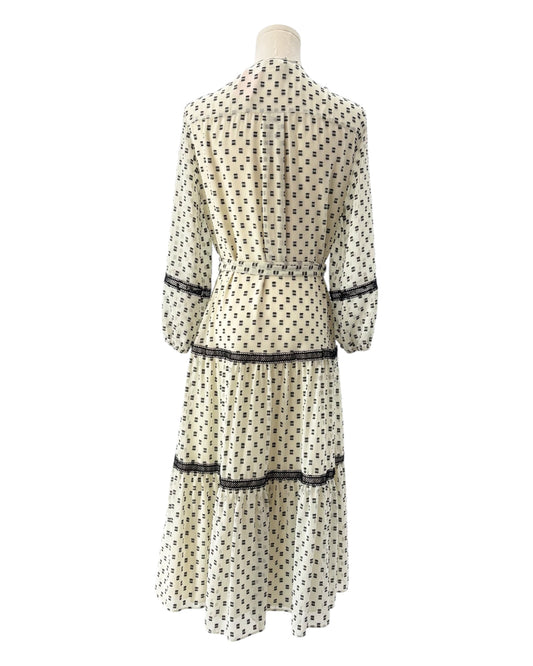 White dress with black print on a mannequin against a white background