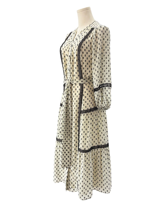 Printed dress on a mannequin against a white background