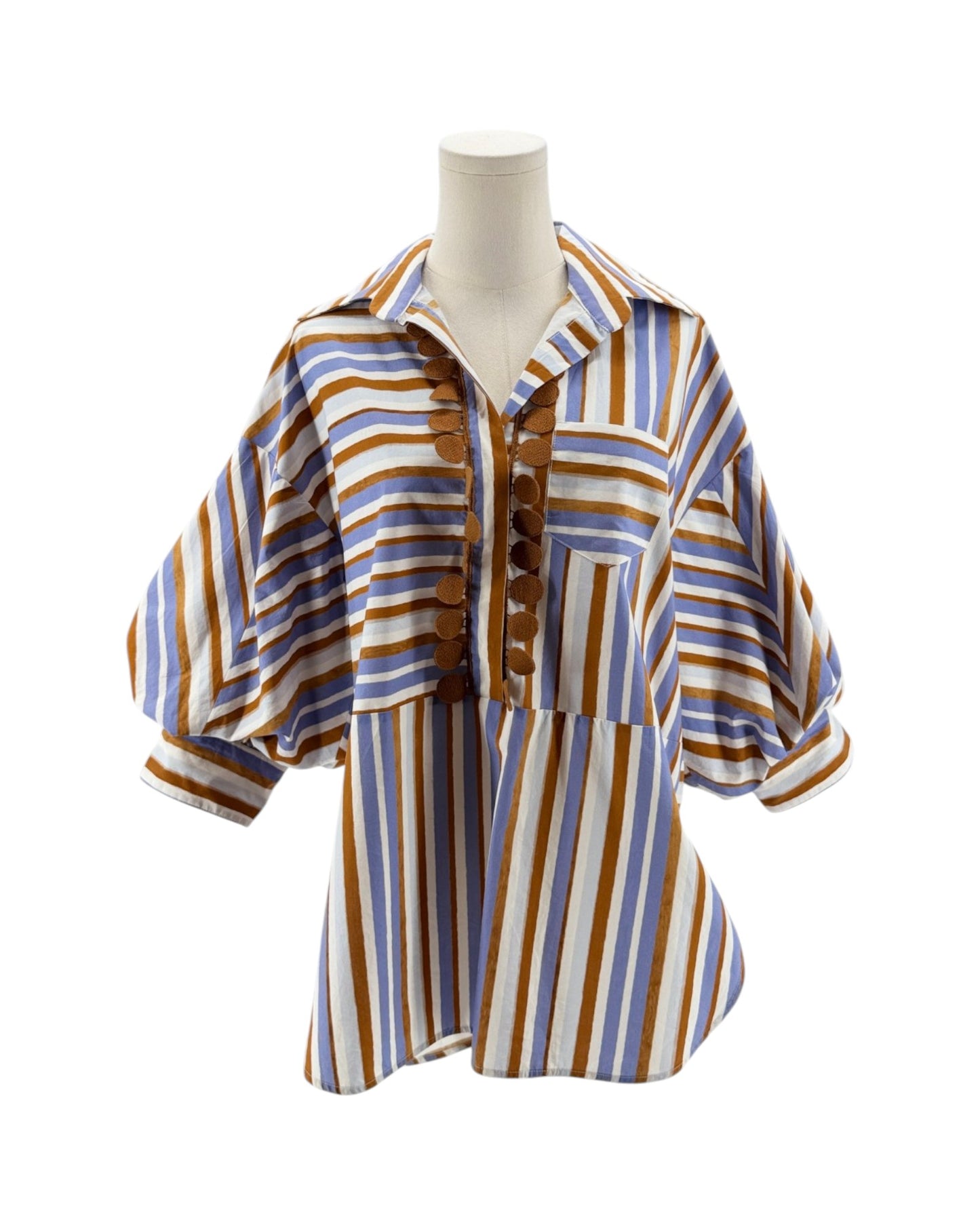 Striped shirt on a mannequin against a white background