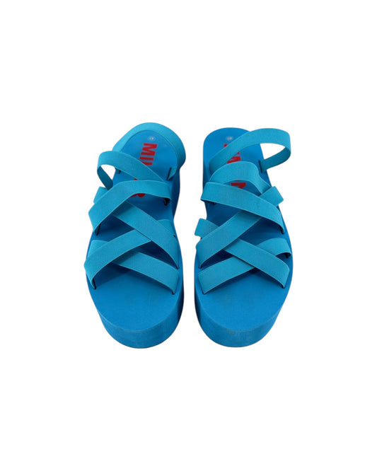 A pair of bright blue strappy sandals with a thick platform sole, shown from a top-down view on a plain white background.