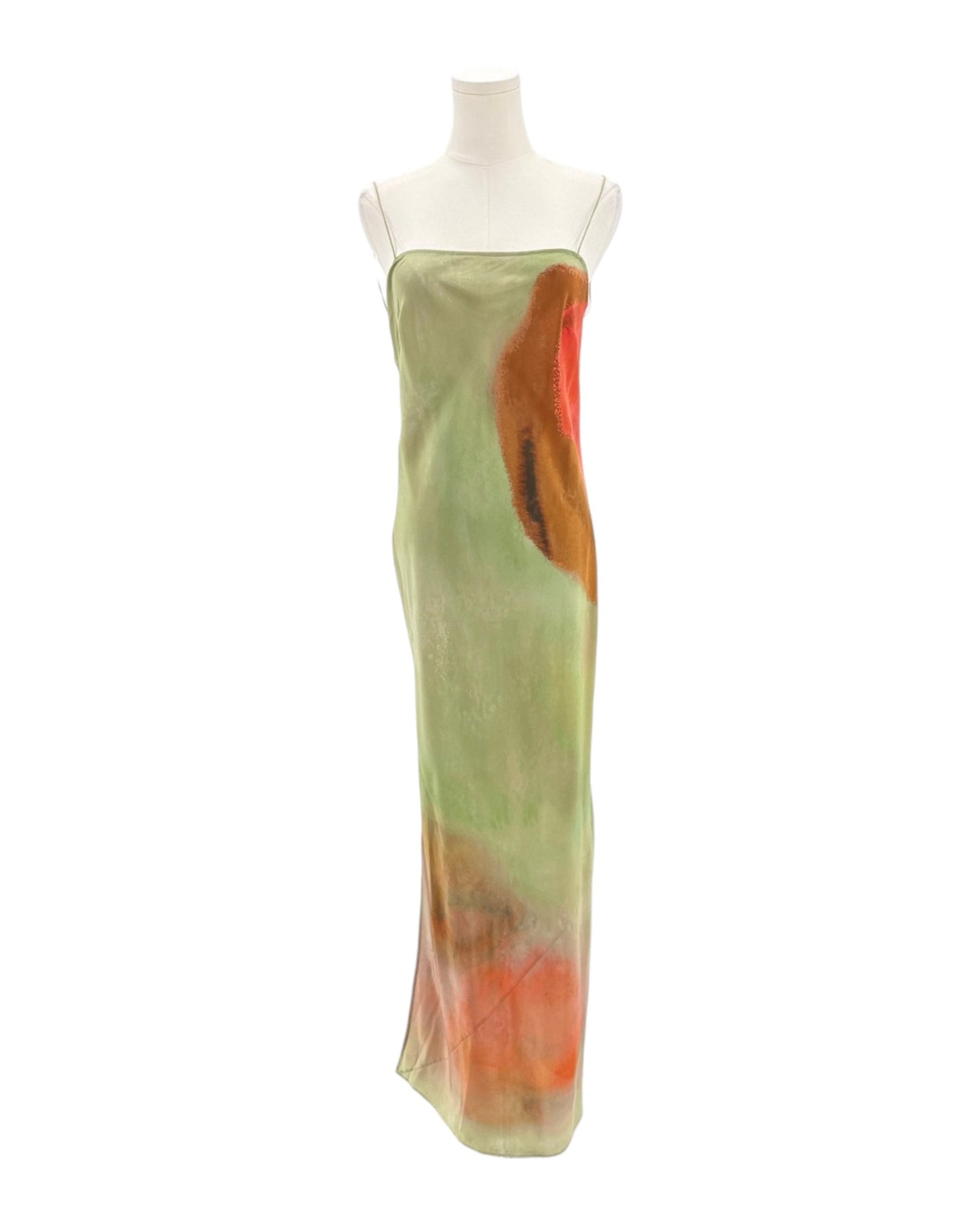 Mannequin wearing a long, light green dress with orange accents on a white background