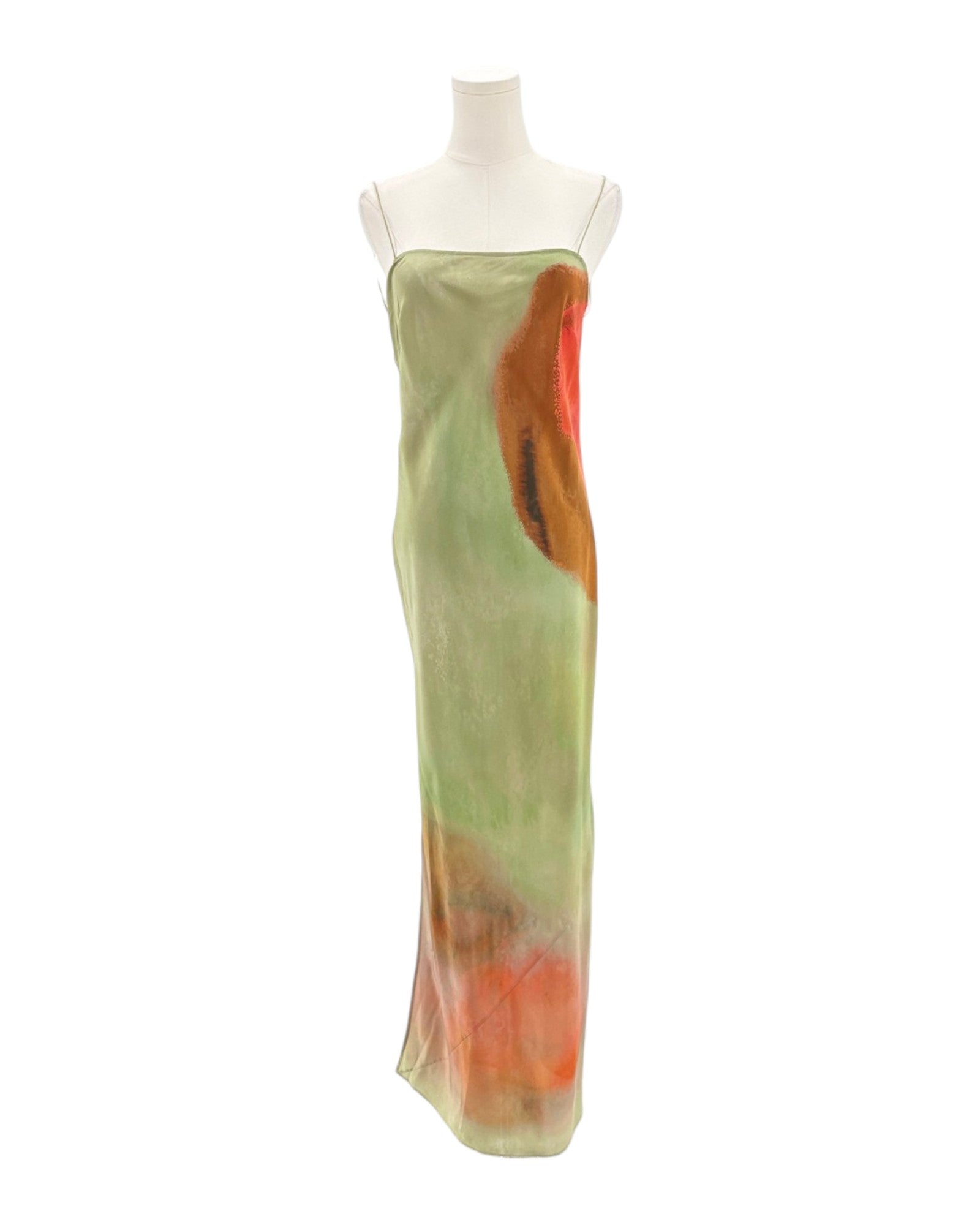 Mannequin wearing a long, light green dress with orange accents on a white background