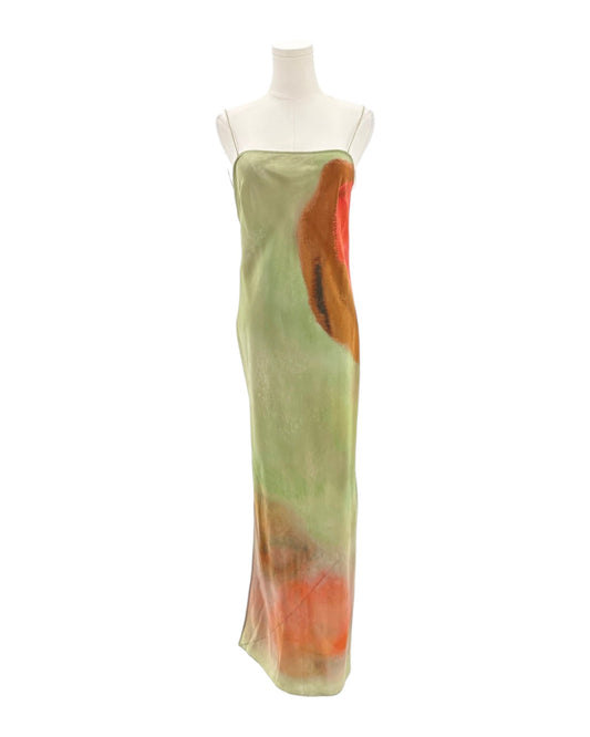 Mannequin wearing a long, light green dress with orange accents on a white background