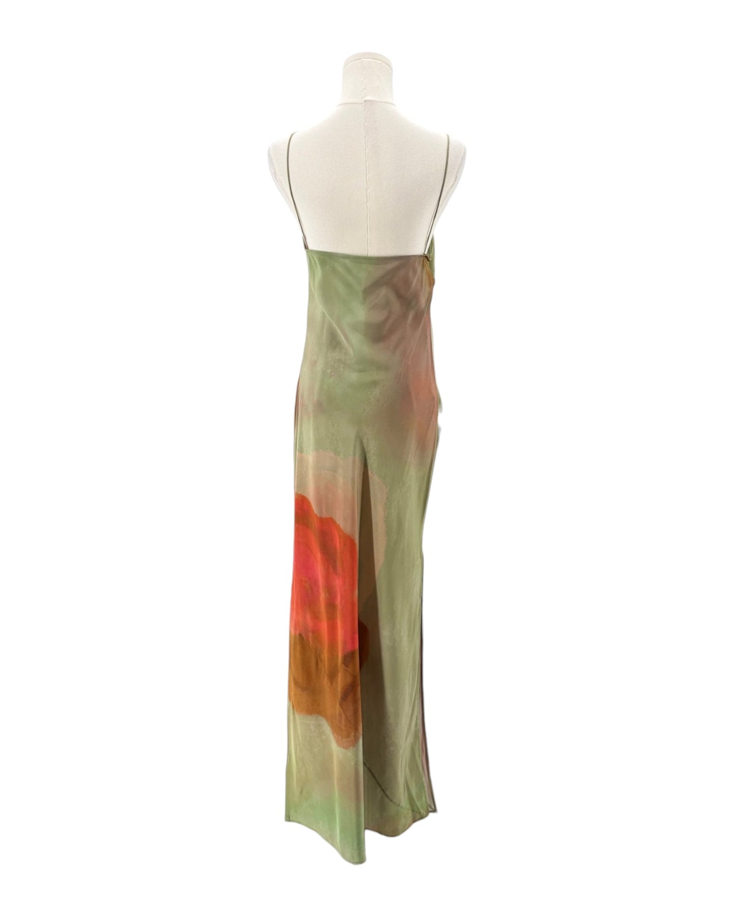Mannequin wearing a long, sleeveless dress with a gradient design on a white background