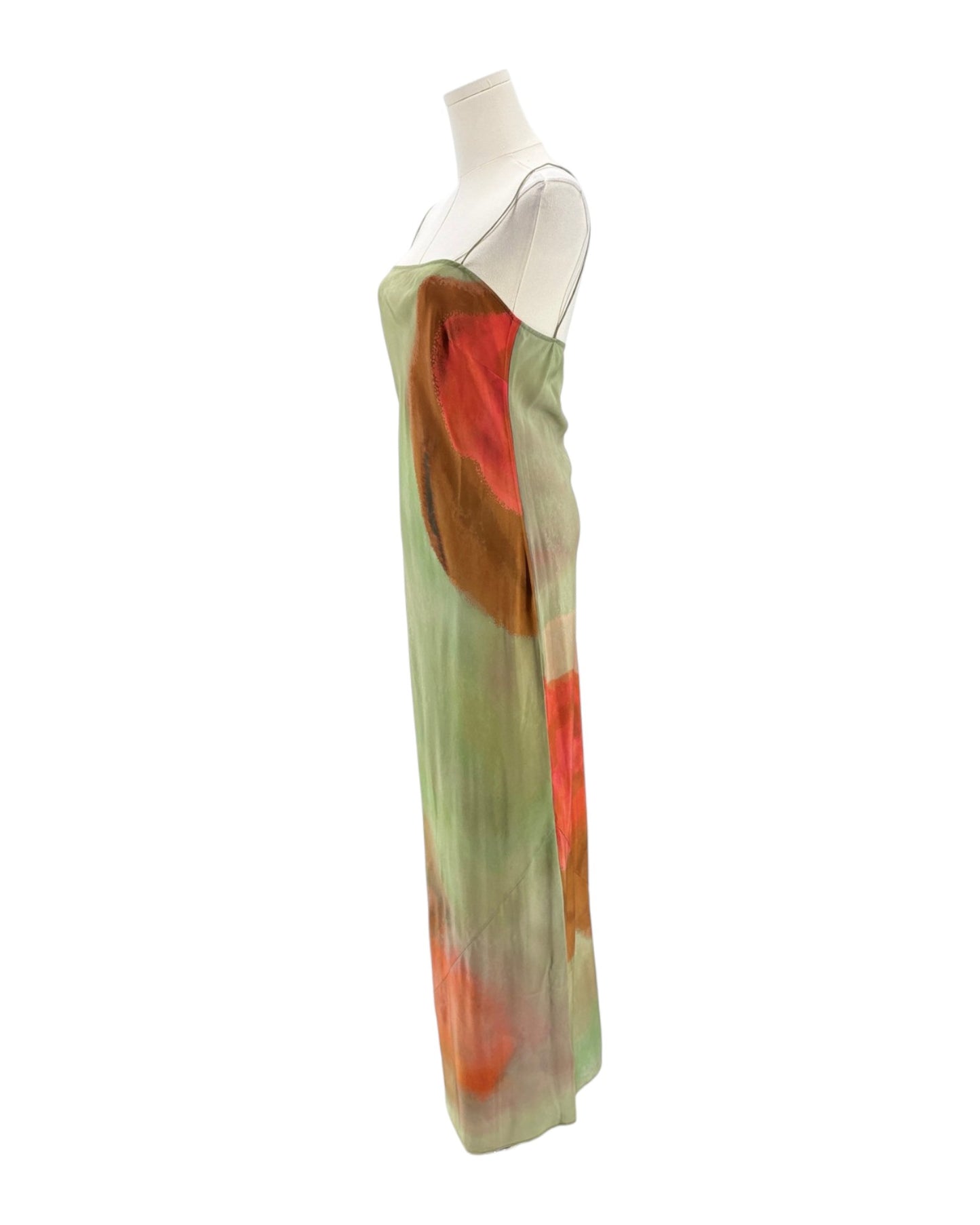 Mannequin wearing a long, colorful dress with abstract patterns on a white background