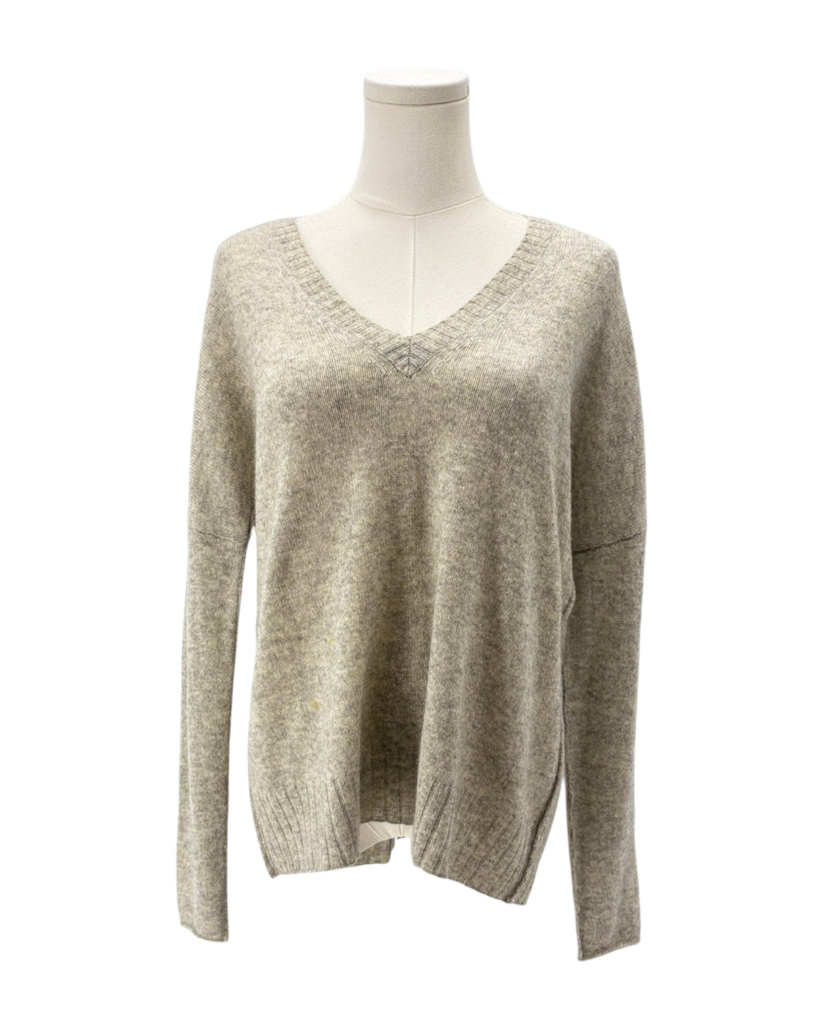 Beige sweater on a mannequin against a white background
