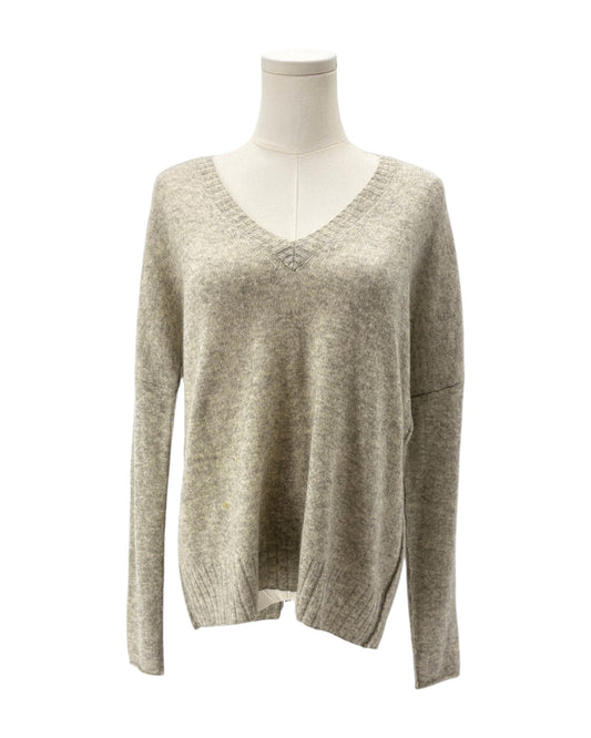 Beige sweater on a mannequin against a white background