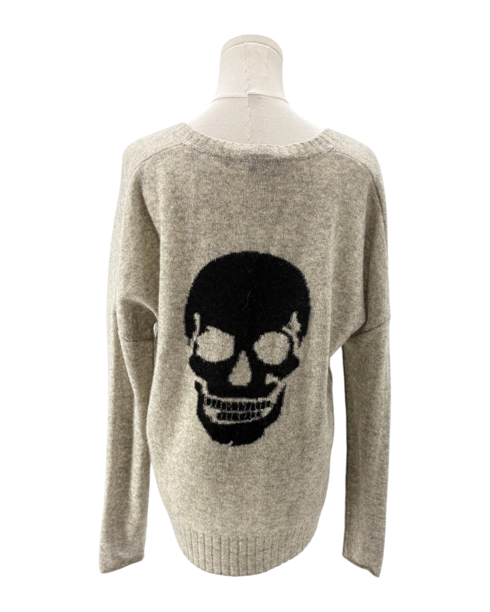 Gray sweater with a black skull design on a mannequin against a white background