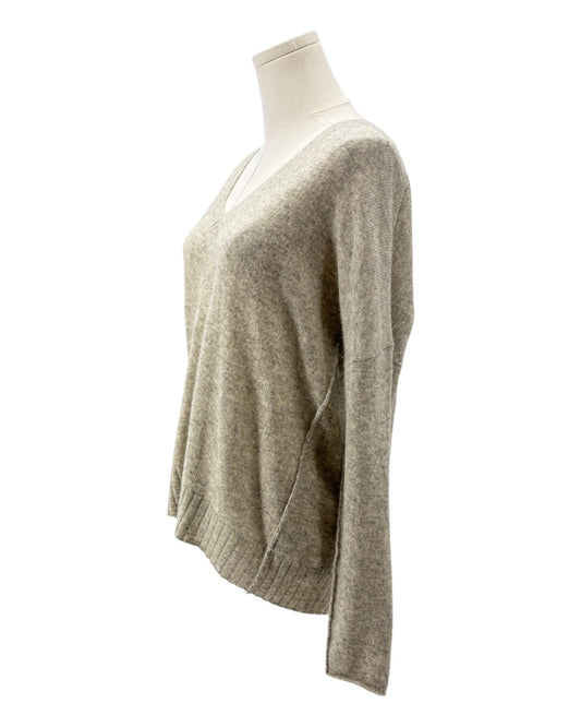 Beige sweater on a mannequin against a white background
