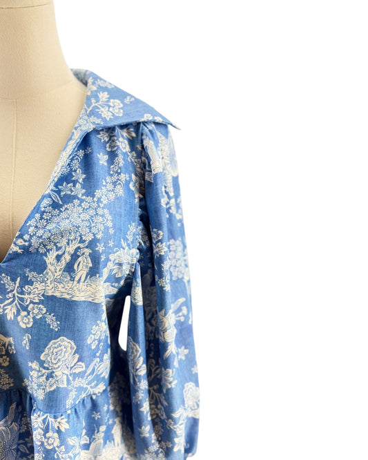 Blue floral patterned fabric draped over a mannequin on a white background