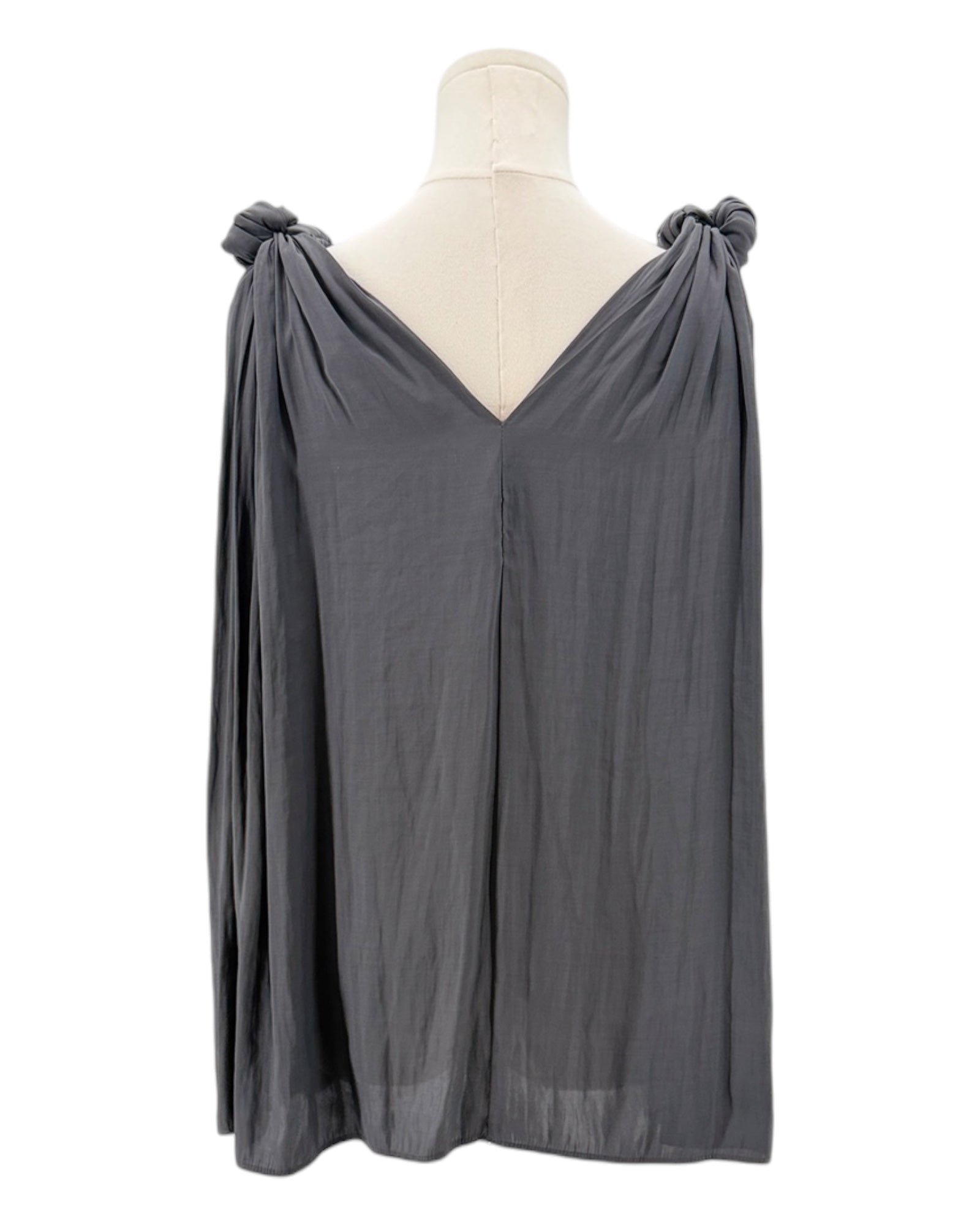 Black top with knot details on a mannequin against a white background