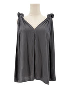 Black sleeveless top with bow details on a mannequin against a white background