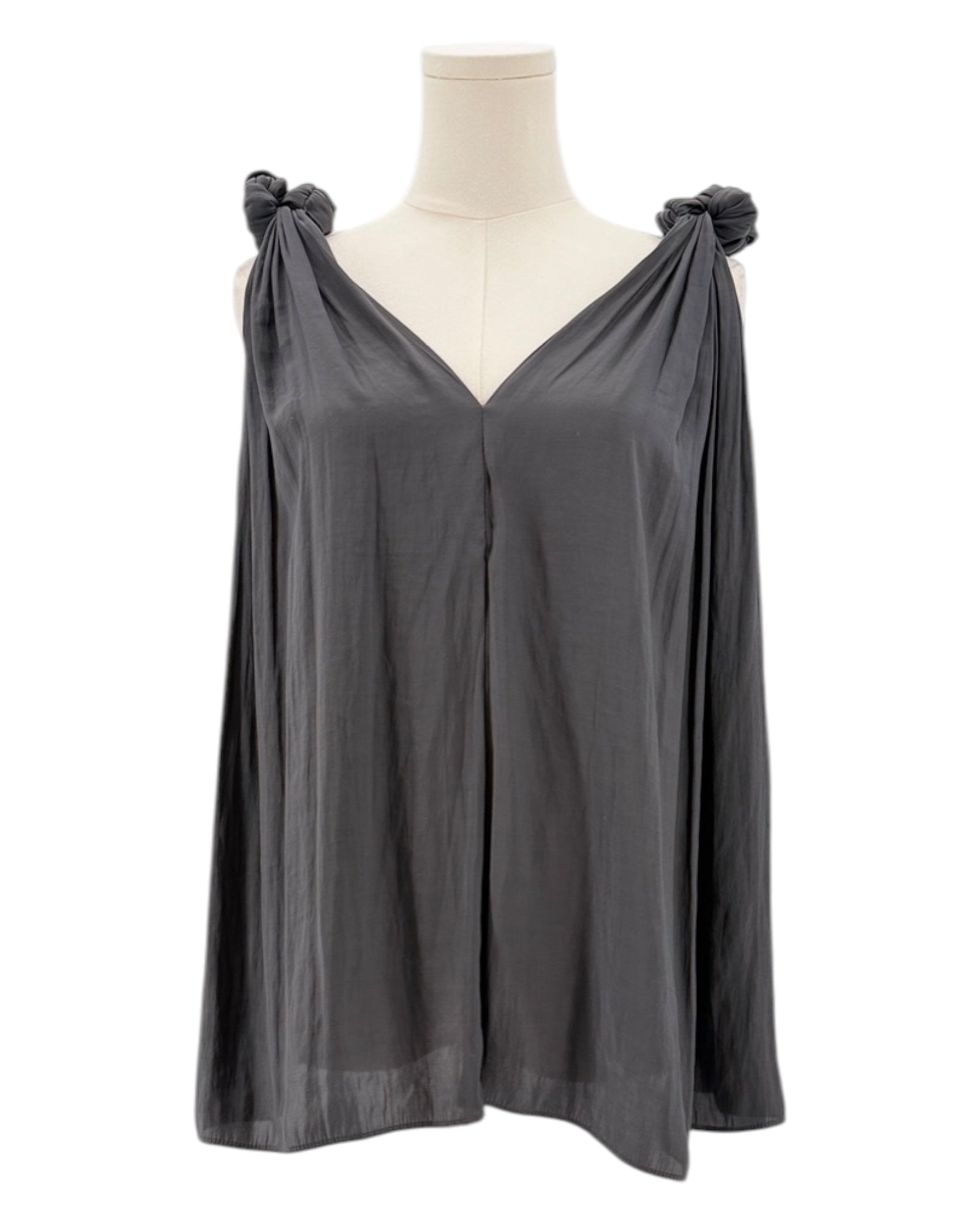 Black sleeveless top with bow details on a mannequin against a white background