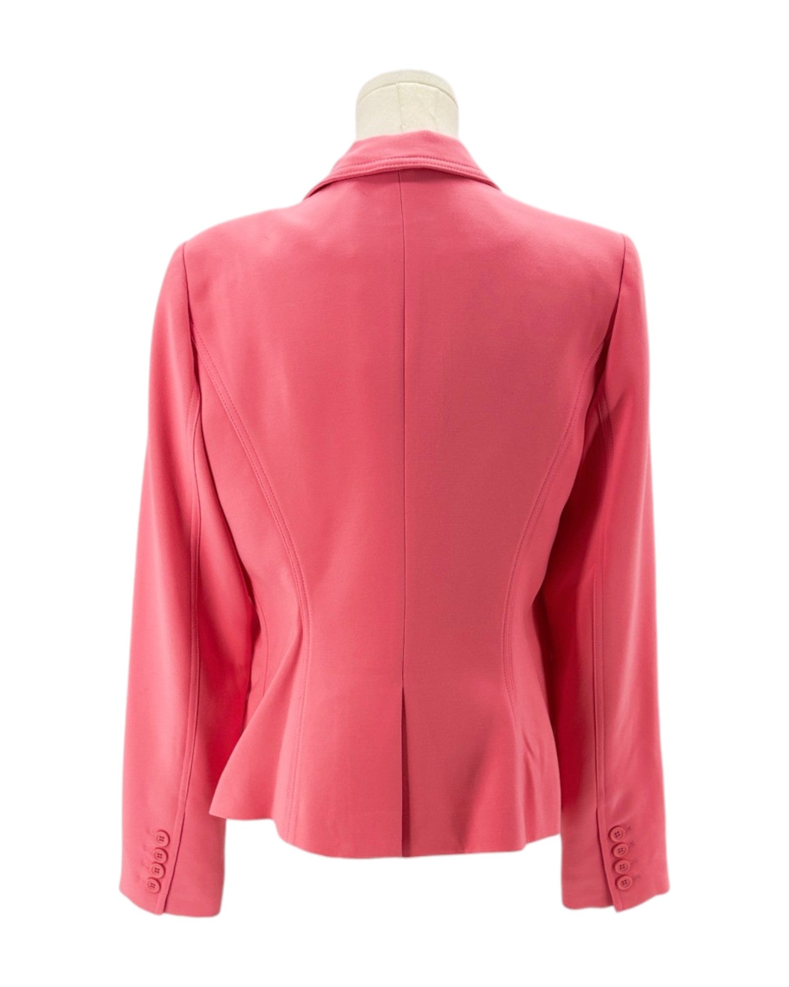 Pink blazer on a mannequin against a white background