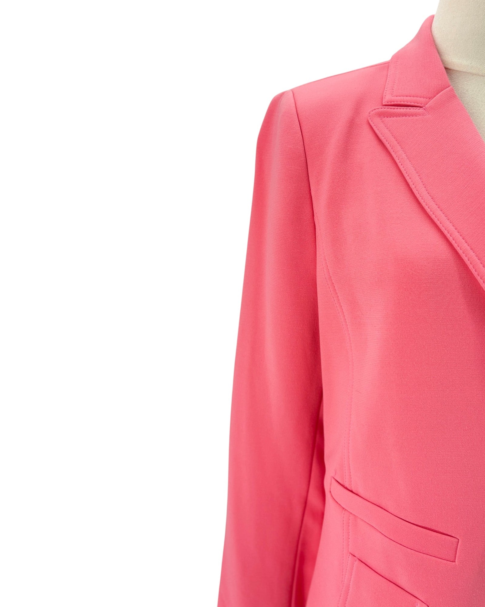 Pink blazer on a mannequin against a white background